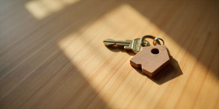 House key with heart-shaped keychain for Valentine real estate.